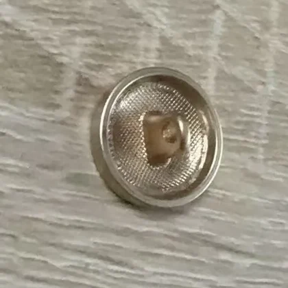 Bouton métal personnalisé vu du revers, avec sa queue de fixation